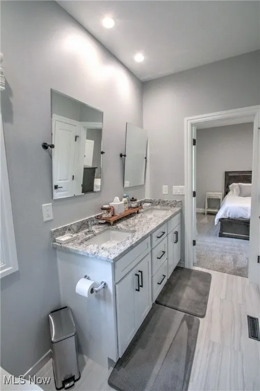 Jack and Jill Full bathroom with double vanity, connected bathroom, and recessed lighting