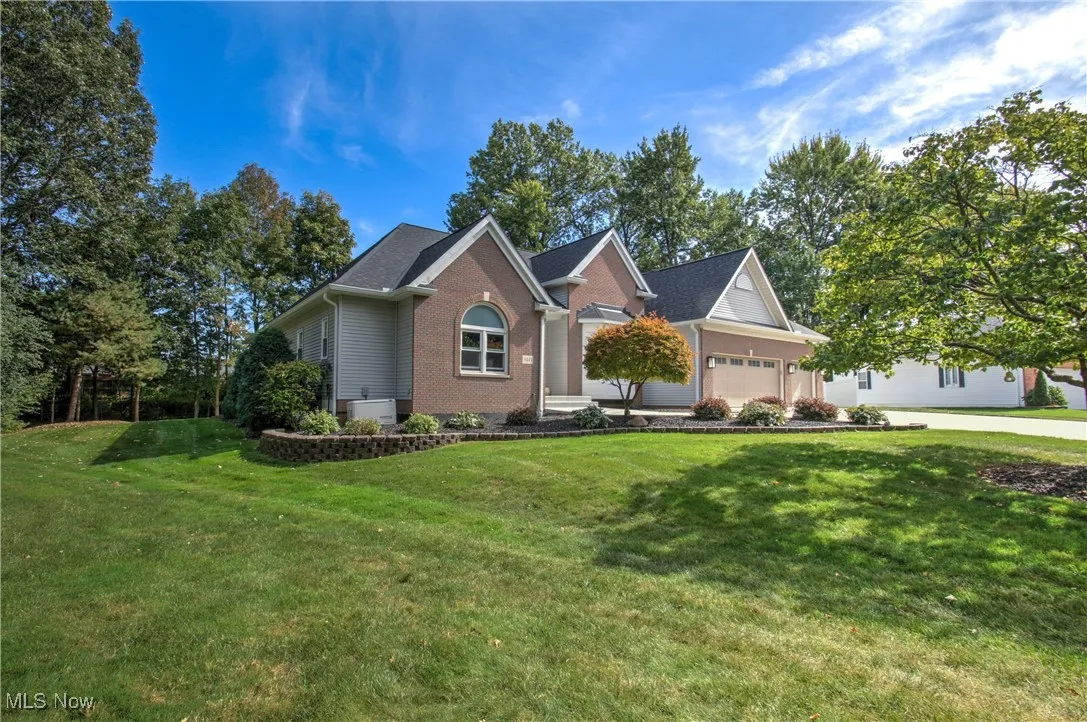 View of front of house featuring a front yard, brick siding, and a porch