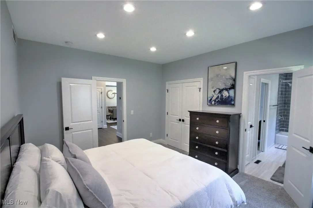 Bedroom with a closet, recessed lighting, and carpet flooring
