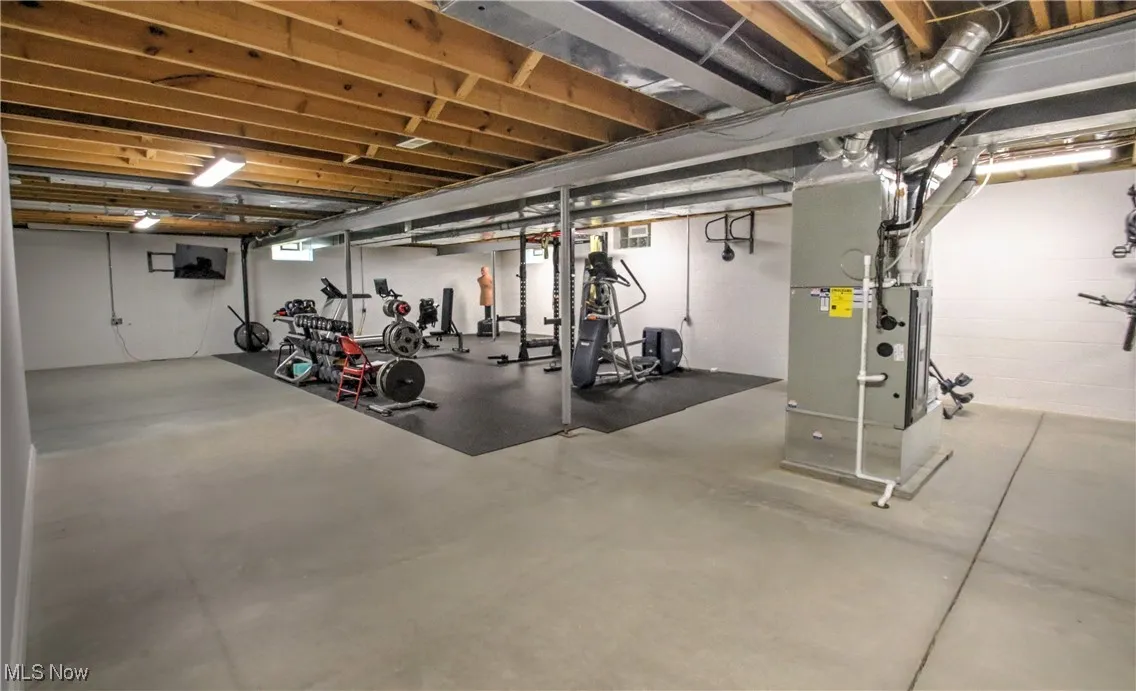 Workout room with concrete flooring and heating unit