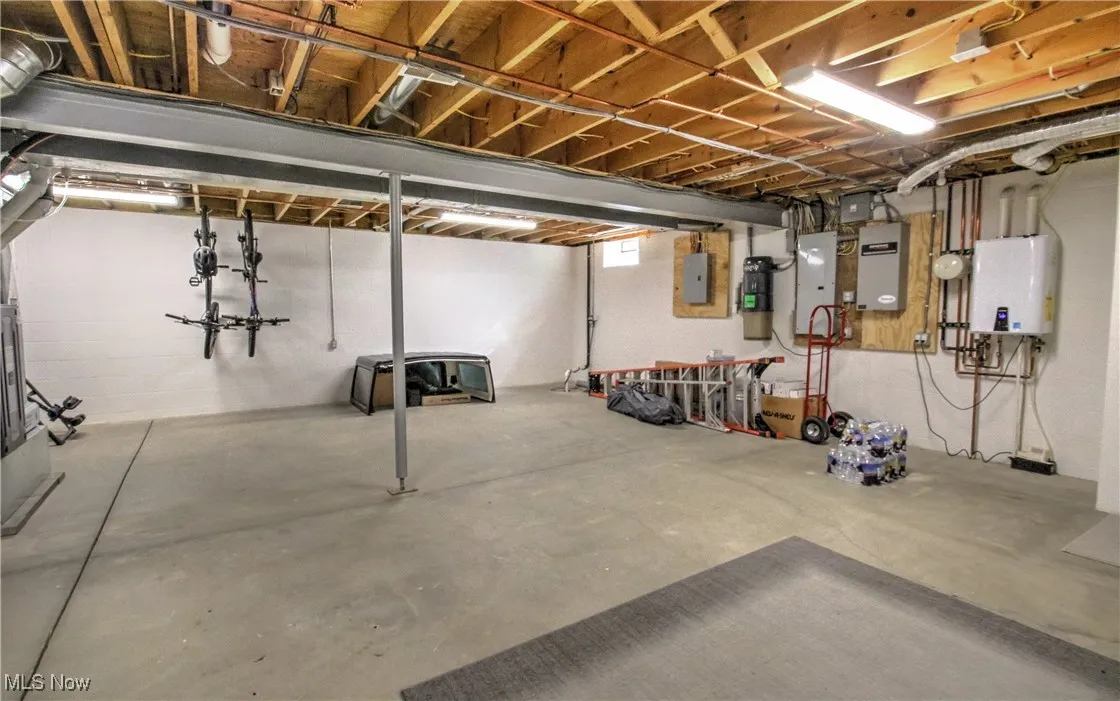 Basement featuring water heater and electric panel
