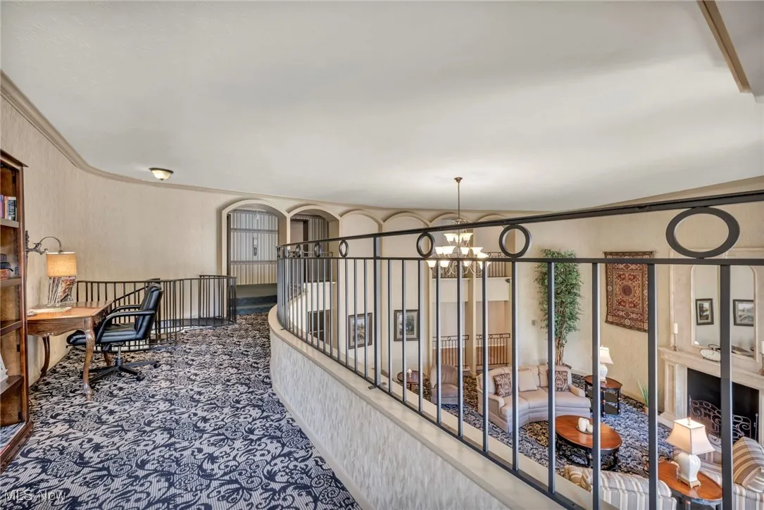 Office space featuring ornamental molding, a chandelier, and dark colored carpet