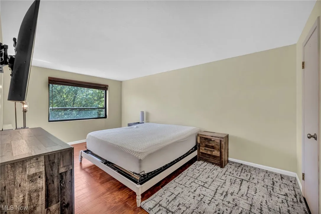 Bedroom featuring wood finished floors and baseboards