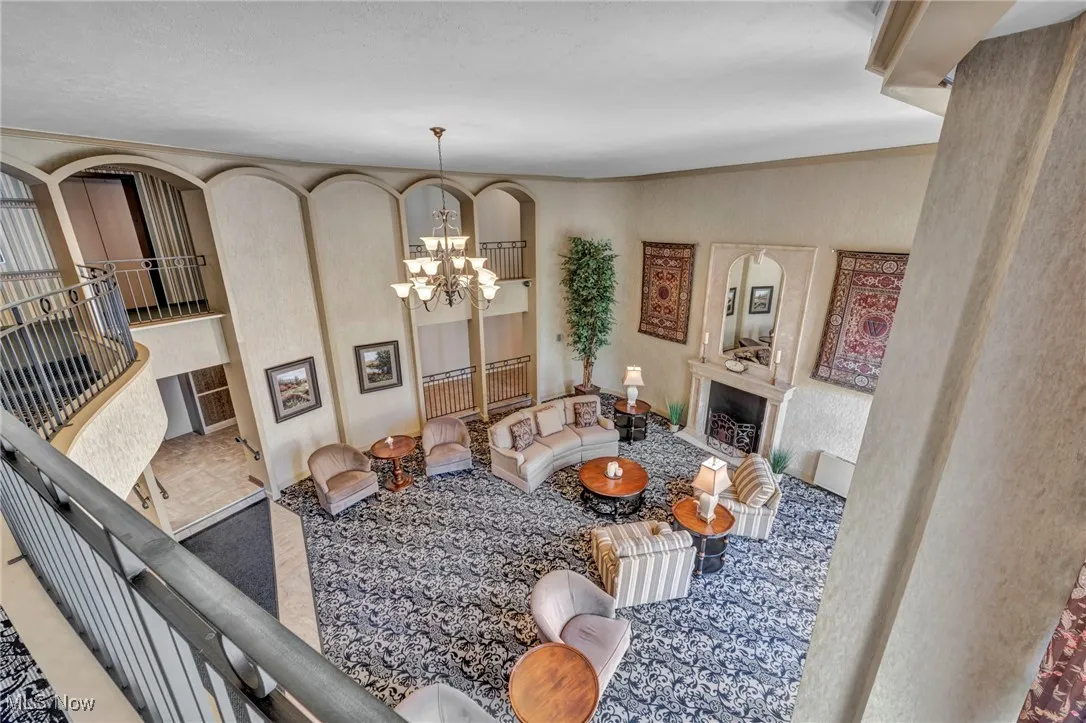 Living room with a fireplace and a chandelier