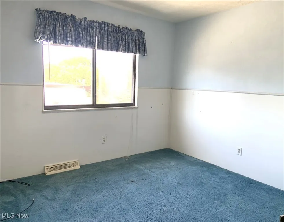 Spare room featuring carpet floors