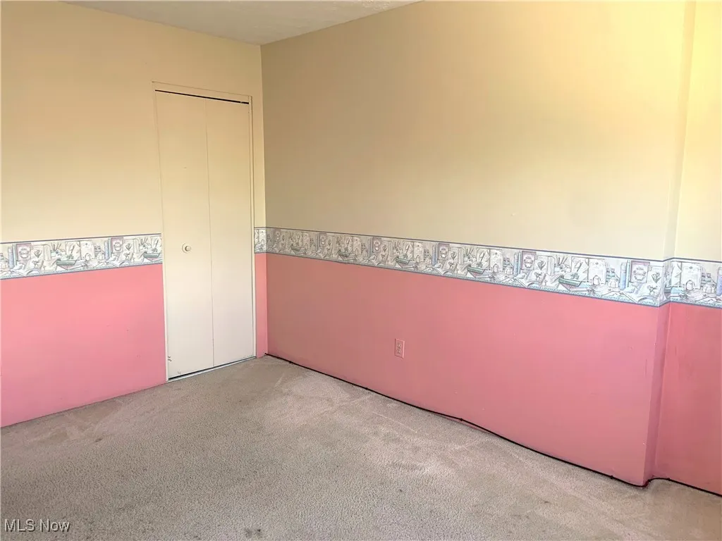 Unfurnished room featuring carpet flooring and a textured ceiling