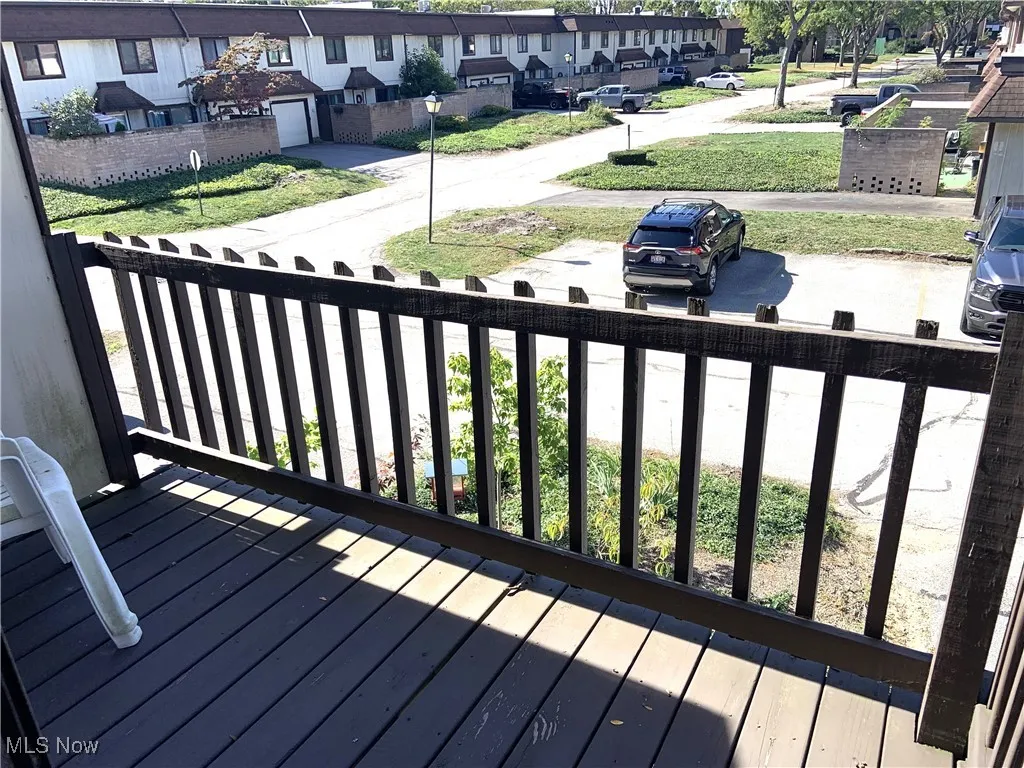 Wooden terrace featuring a residential view