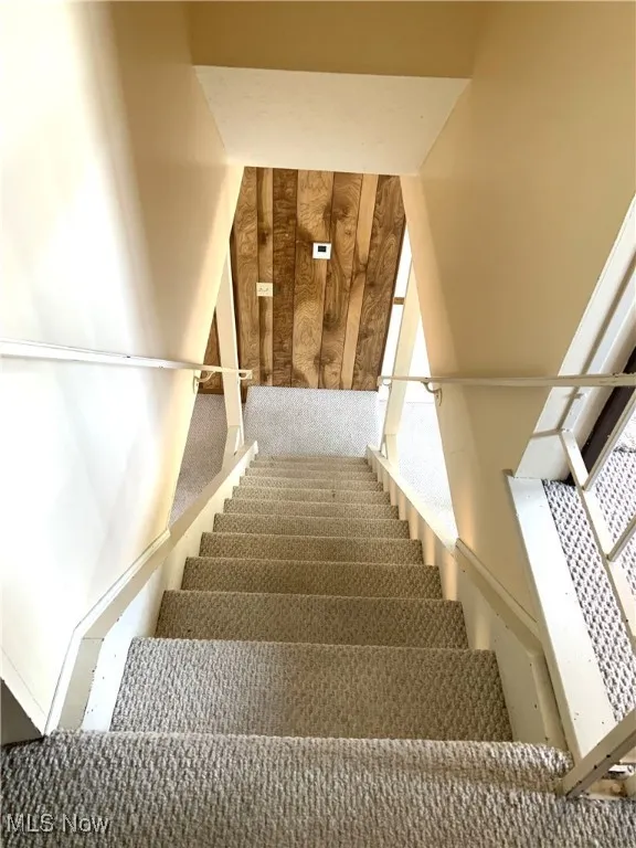 View of stairs going down from bedroom