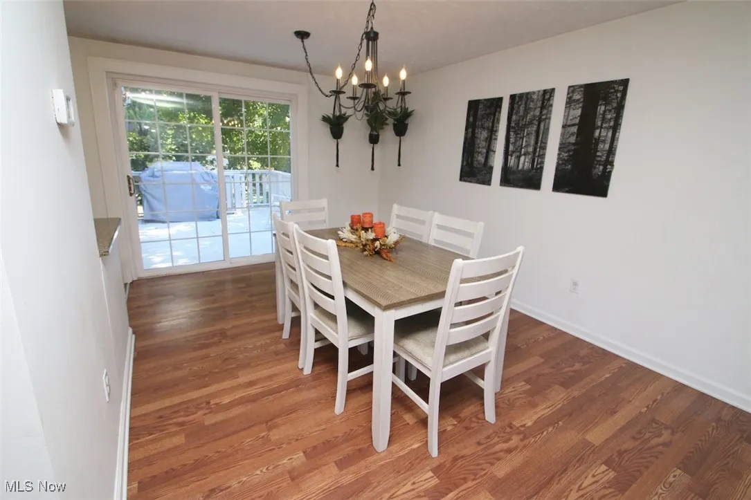 Dining space featuring light wood finished floors and a chandelier