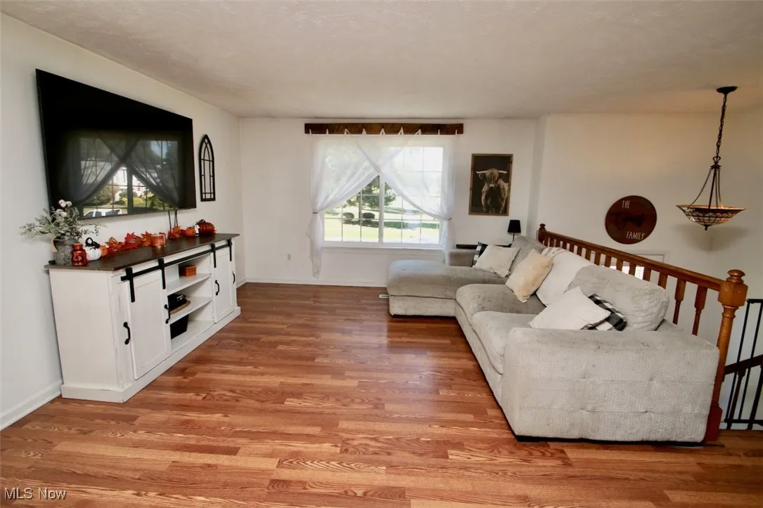 Living room with light wood-style floors and baseboards