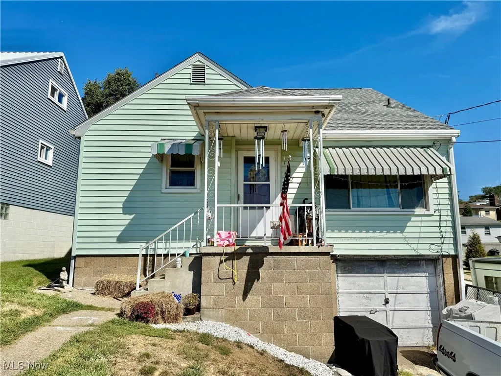 View of front of house featuring roof with shingles and an attached garage