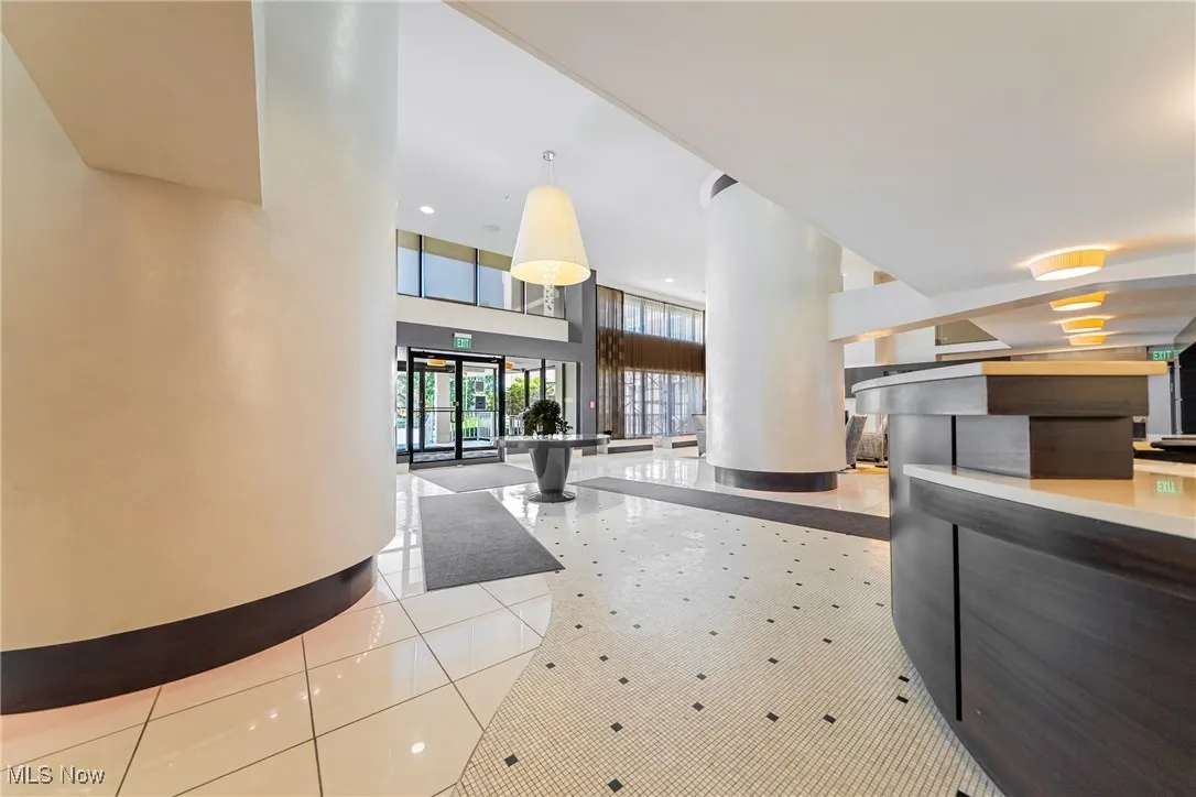 Reception area with french doors, a towering ceiling, and recessed lighting