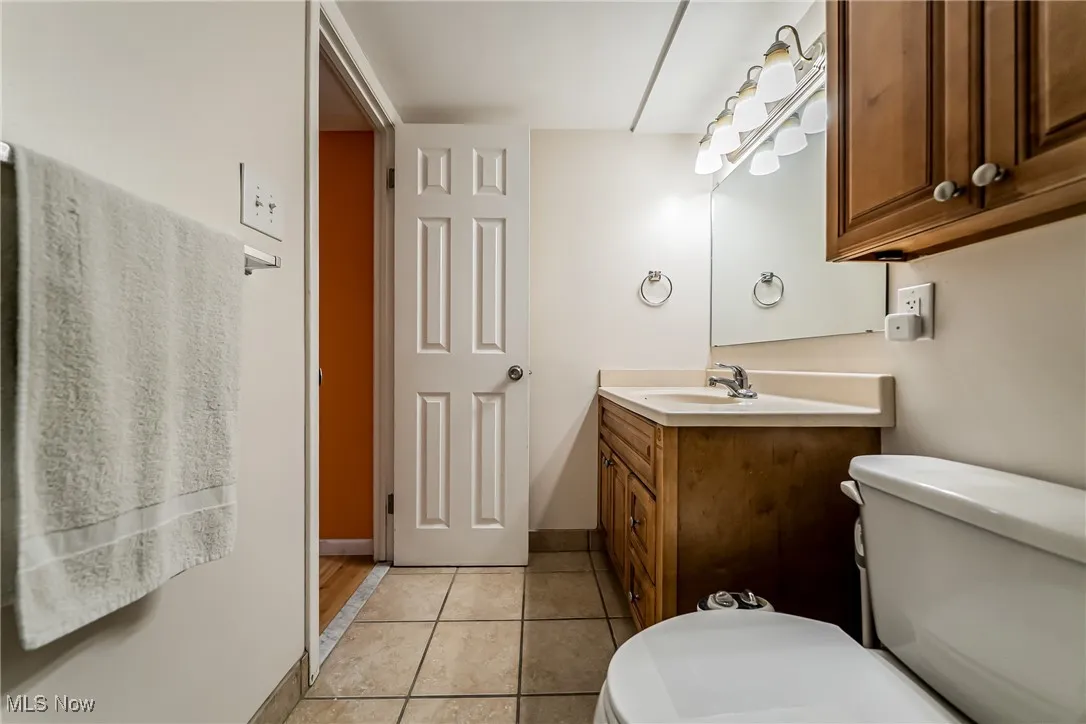 Bathroom featuring light tile patterned flooring and vanity