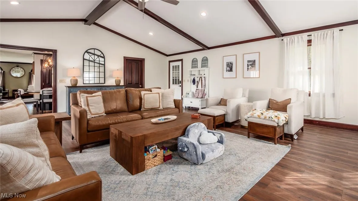 Living room with wood finished floors, recessed lighting, and a ceiling fan