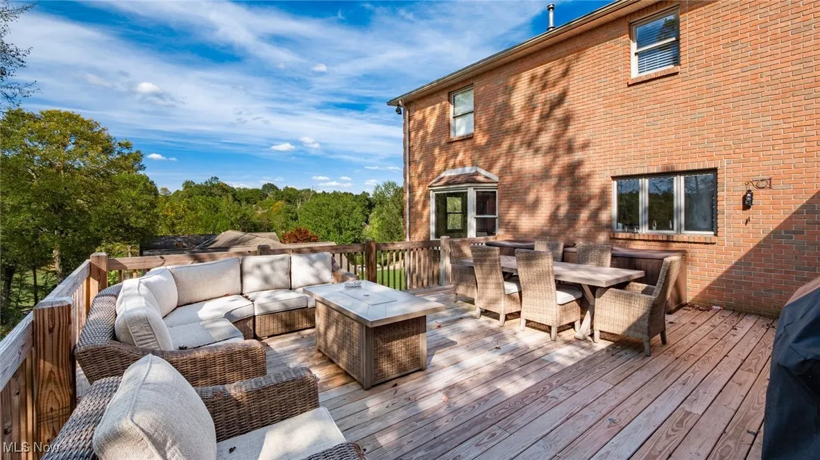 Wooden terrace with outdoor dining area, outdoor lounge area, and area for grilling