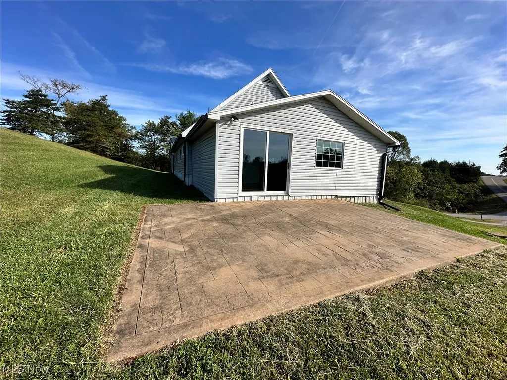 Rear view of house with a yard