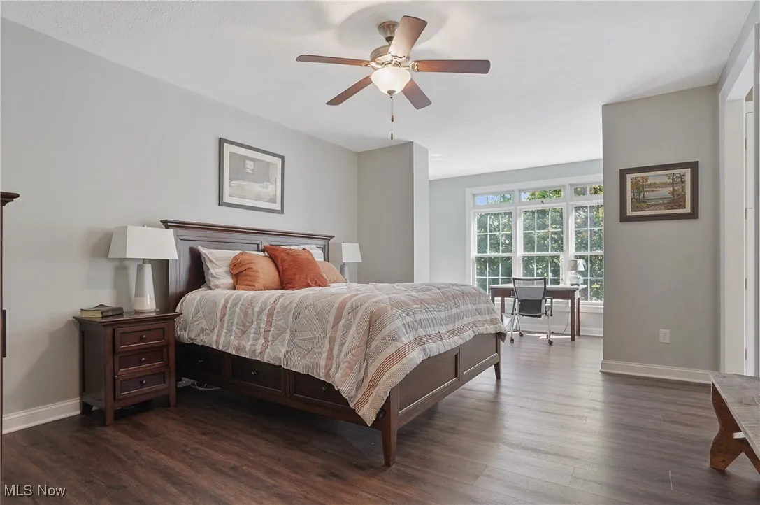 Bedroom featuring dark wood-type flooring and a ceiling fan