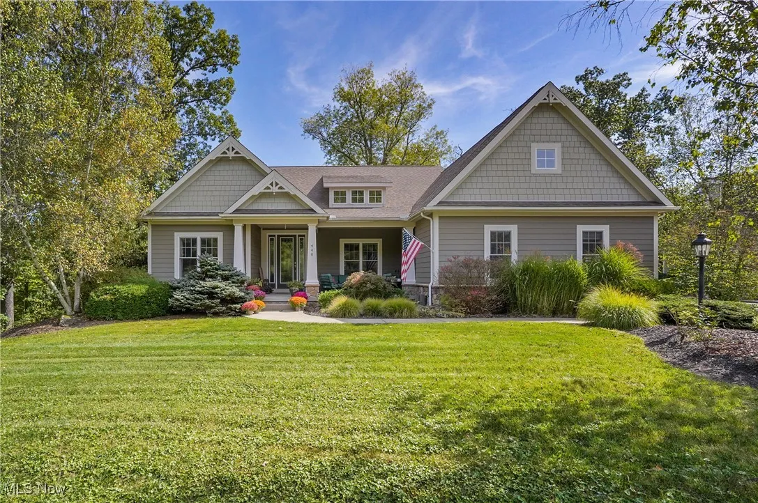 Craftsman-style house with covered porch and a front lawn