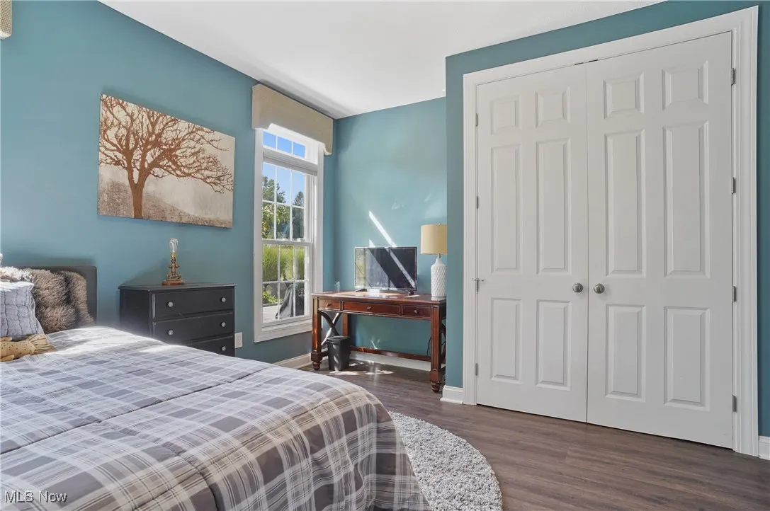 Bedroom with a closet and dark wood finished floors