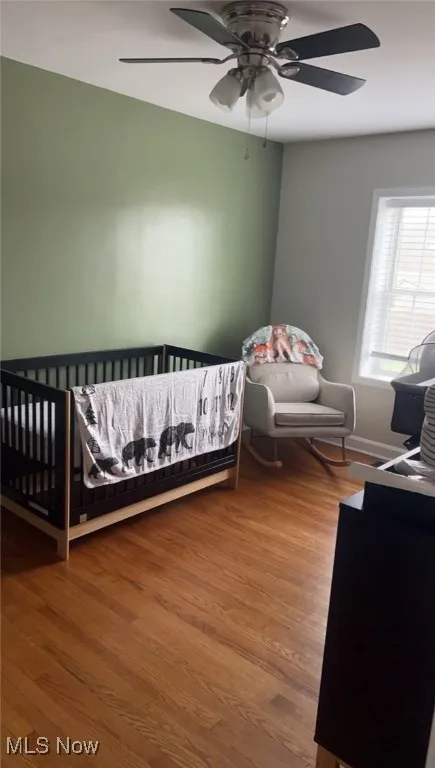 Bedroom featuring wood finished floors and a ceiling fan