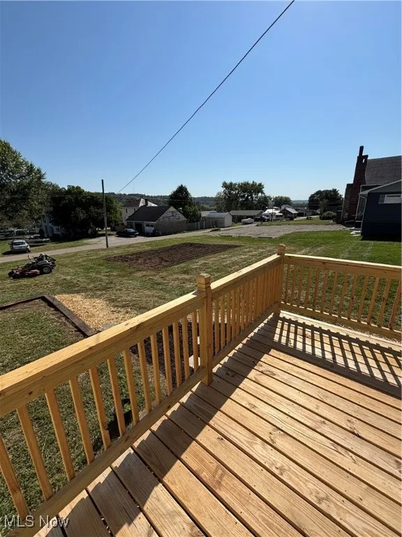Wooden deck with a lawn and a residential view