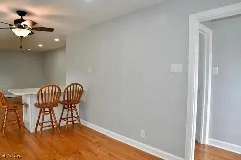 Dining room with light wood-type flooring, recessed lighting, and a ceiling fan