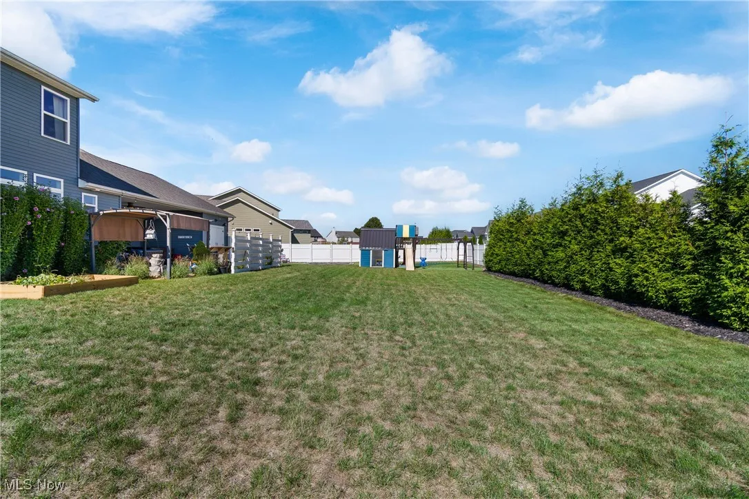 Fenced backyard with a playground