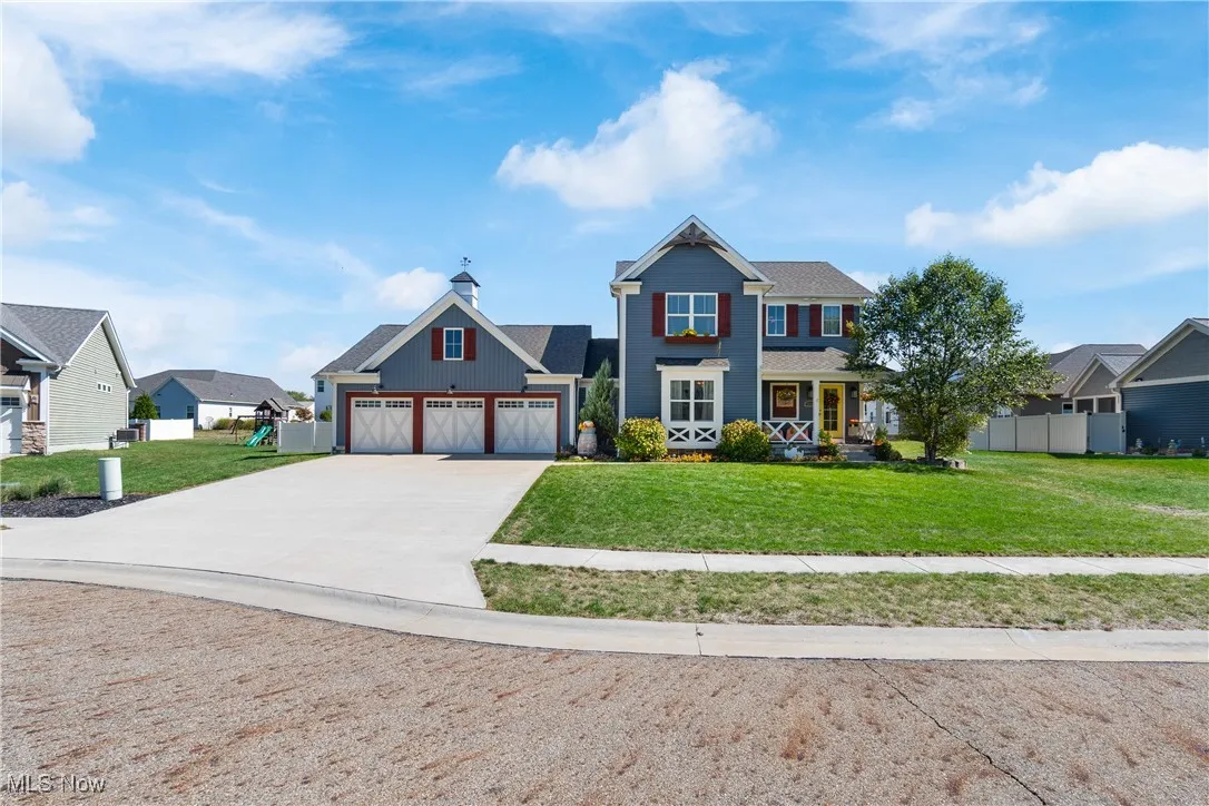 View of front of home featuring concrete driveway, an attached garage, and a porch