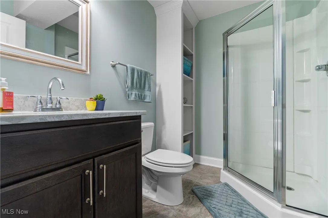 Bathroom with vanity and a shower stall