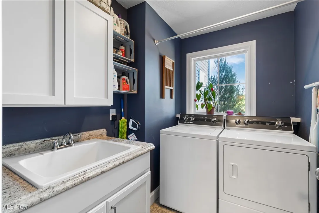 Laundry area with washing machine and clothes dryer and cabinet space
