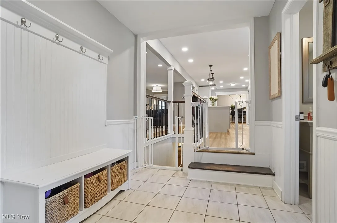 Mudroom featuring recessed lighting, wainscoting, light tile patterned flooring