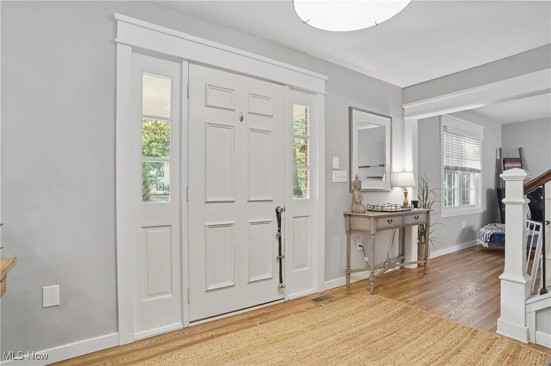 Foyer entrance with wood finished lvt floors and stairway