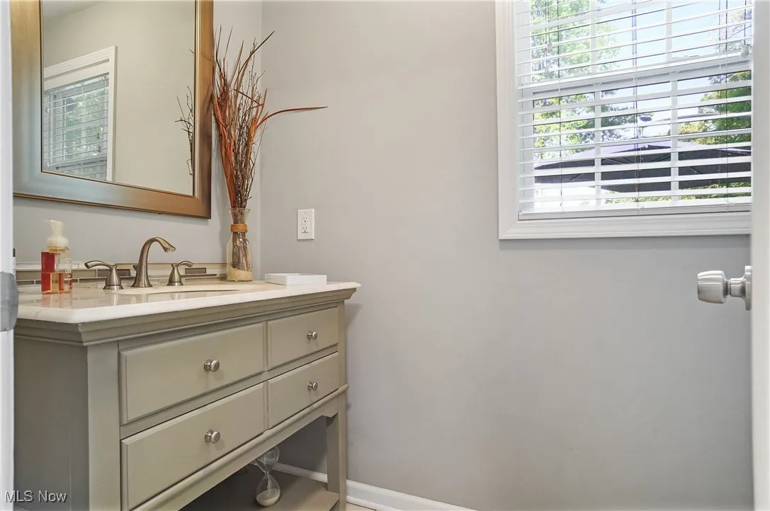 1/2 Bathroom with vanity and plenty of natural light