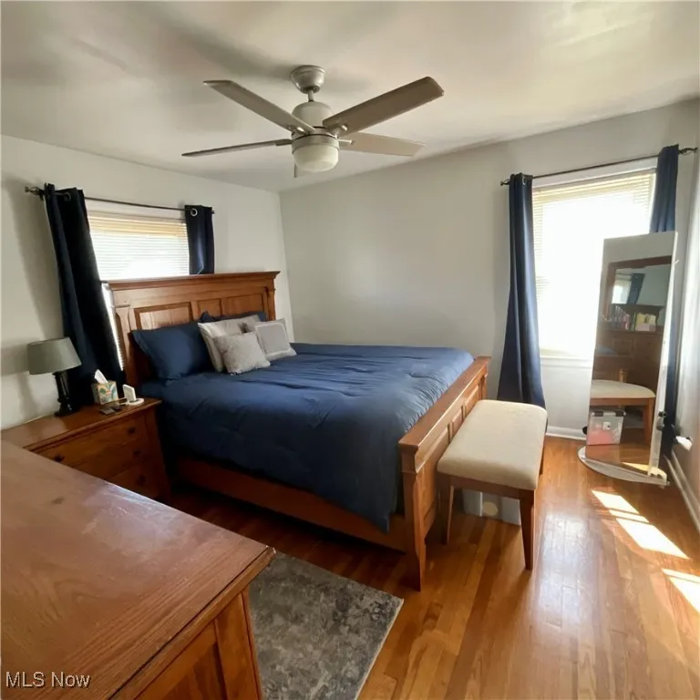 Bedroom with wood finished floors and a ceiling fan