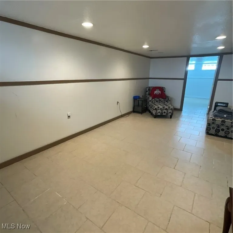 Basement with recessed lighting and ornamental molding