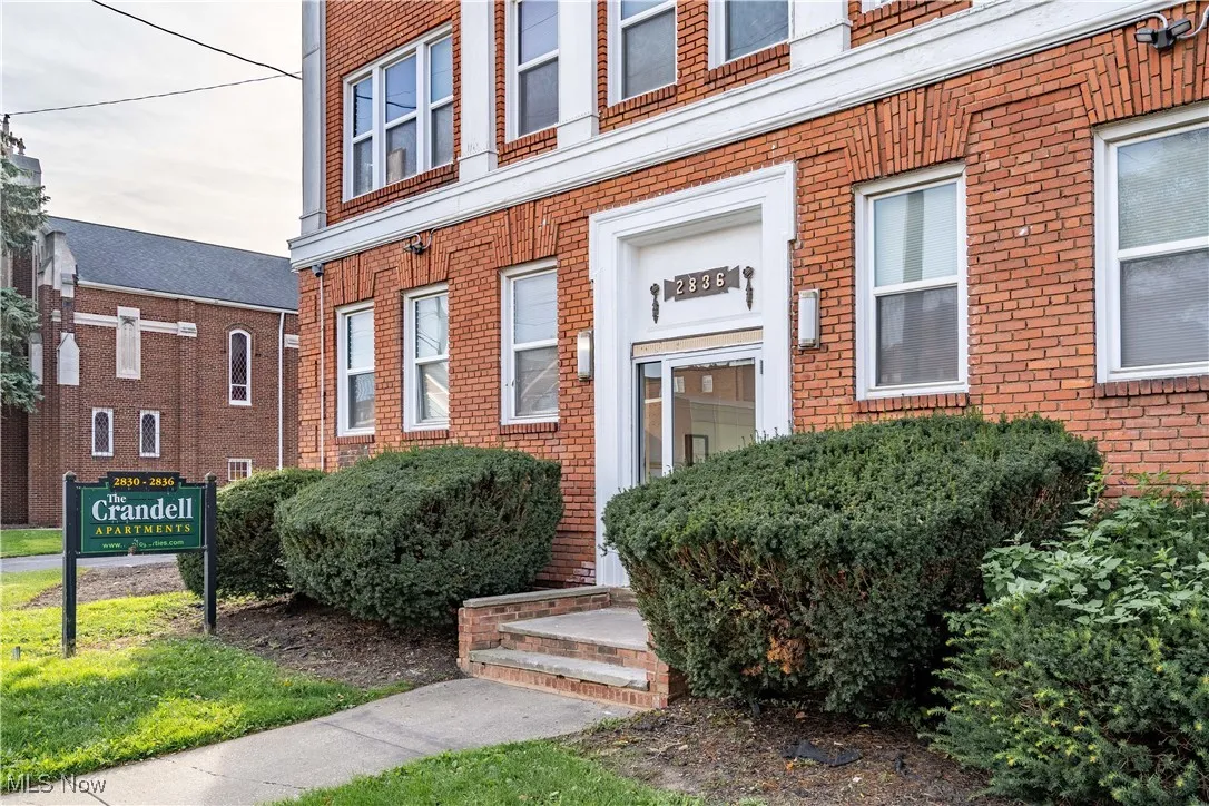 Doorway to property with brick siding