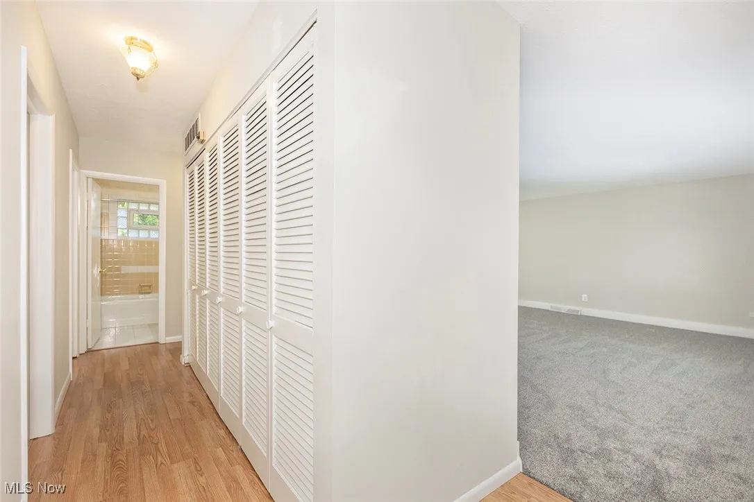 Hall featuring baseboards and light wood-type flooring