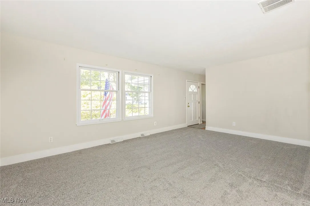 Carpeted living room with baseboards