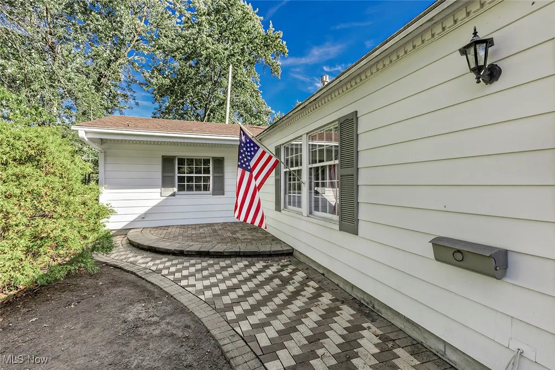 Doorway to property with a patio area