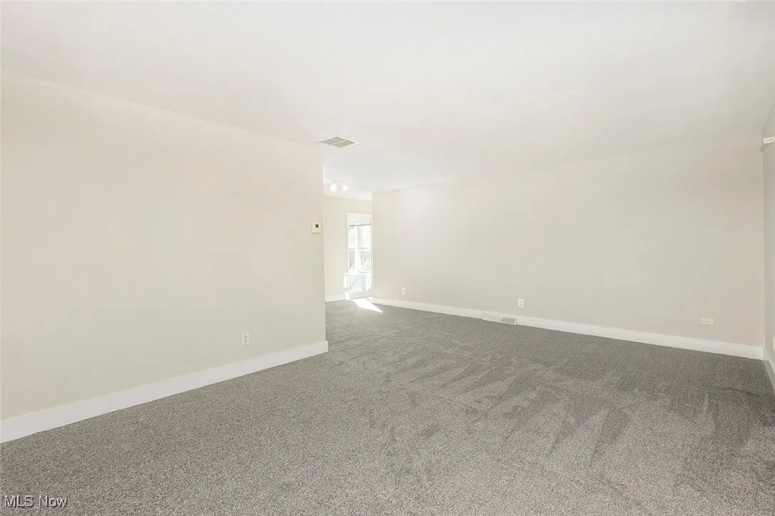 Carpeted living room room featuring baseboards