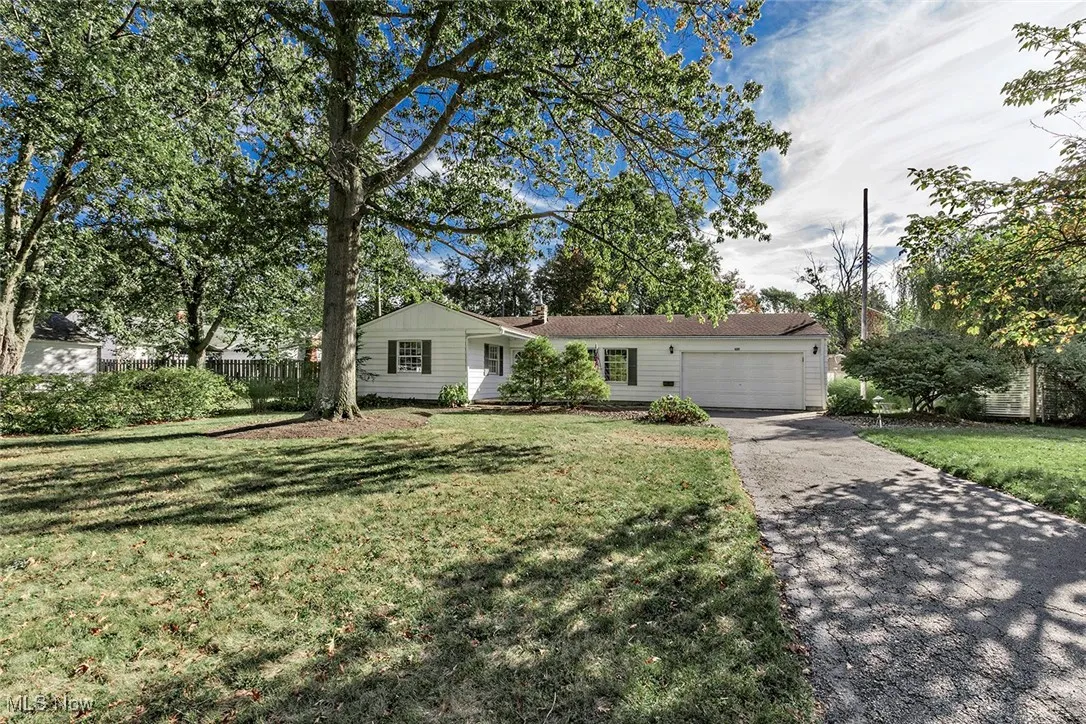Ranch-style home with driveway and an attached garage