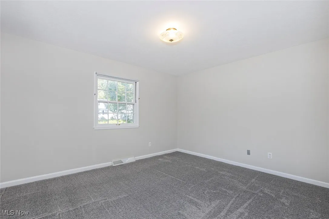 Bedroom with baseboards and carpet