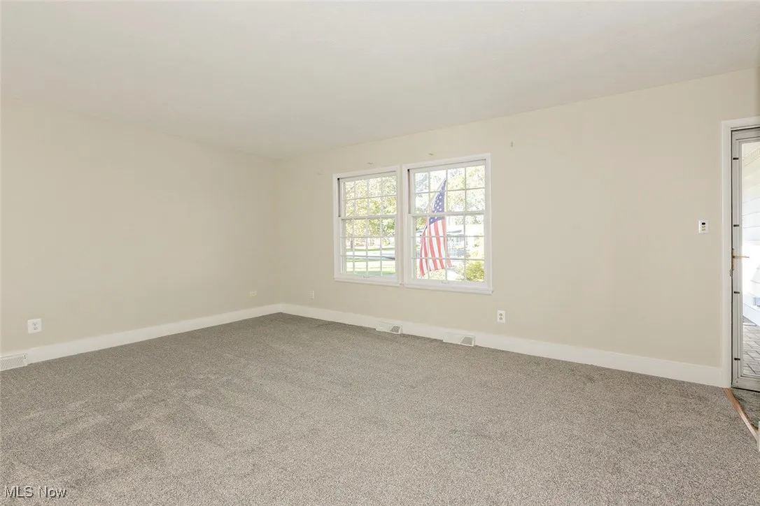 Living room featuring baseboards and carpet flooring