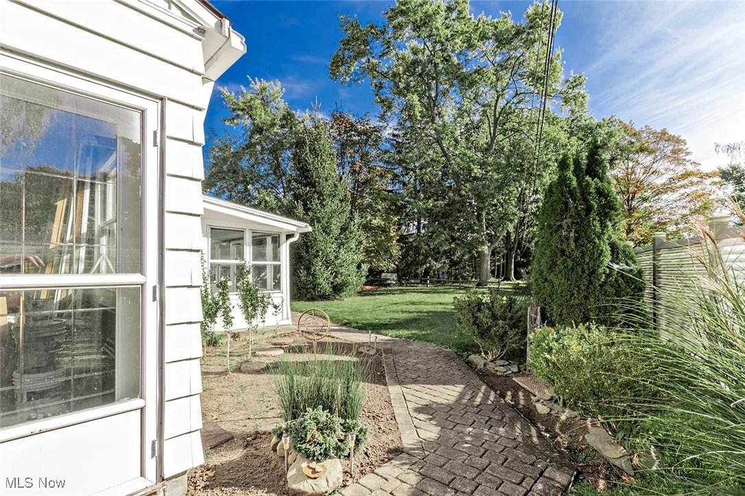 View of green lawn with an enclosed porch.