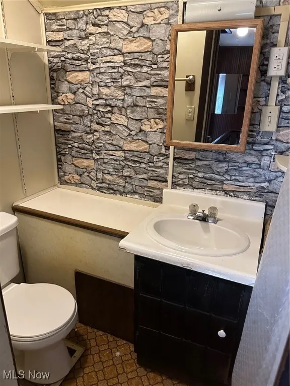 Half bath with vanity and toilet