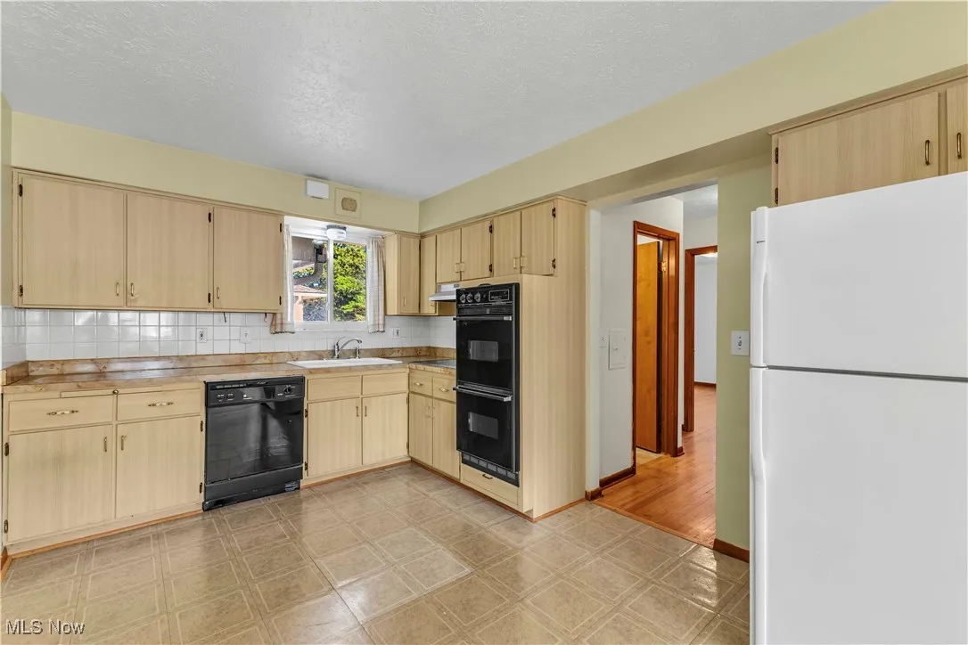 Kitchen with dishwasher, double wall oven, and cooktop