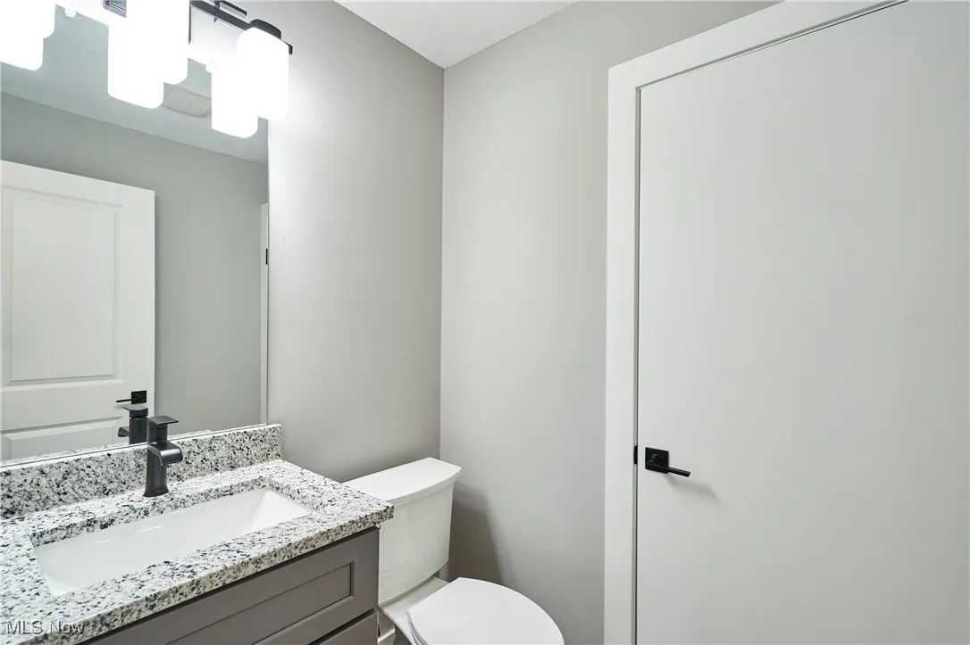 Bathroom featuring vanity and toilet