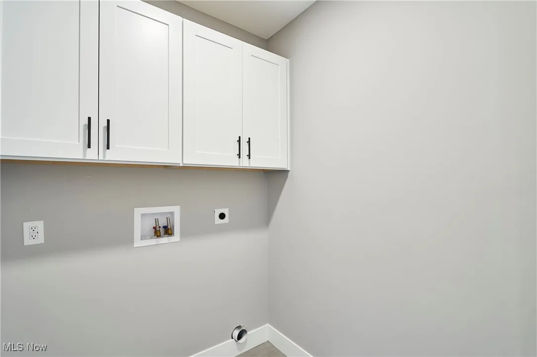 Laundry room featuring cabinets, hookup for an electric dryer, and washer hookup