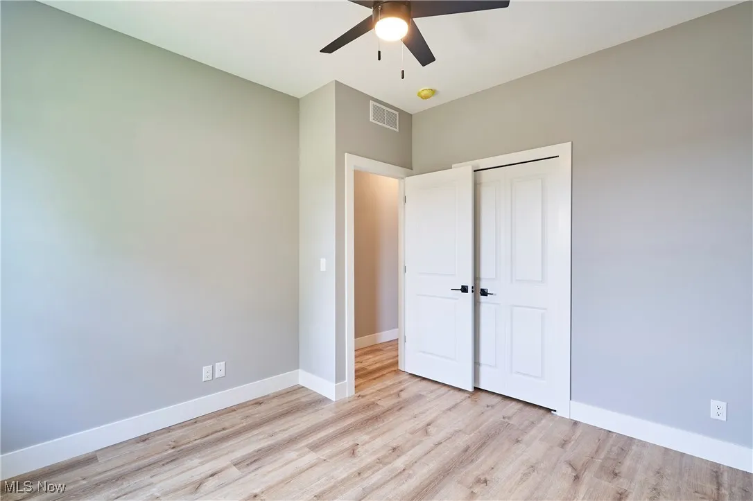 Unfurnished bedroom featuring a closet, ceiling fan, and light hardwood / wood-style floors