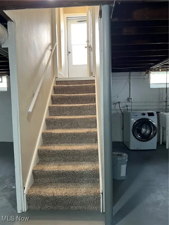 Stairs featuring finished concrete flooring